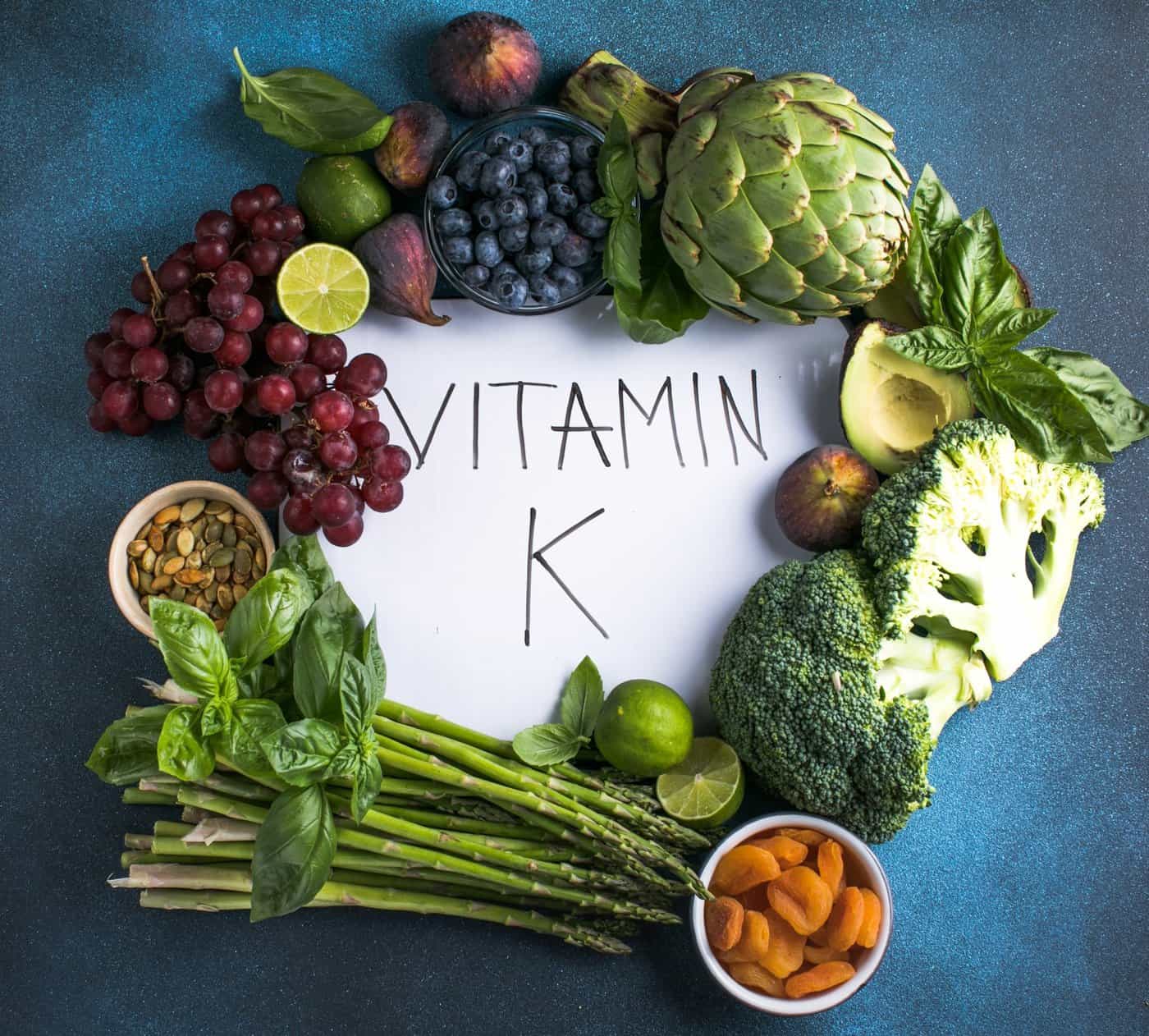 A flat lay of vitamin K-rich foods such as broccoli and grapes displayed as natural ingredients used by NutriFusion.