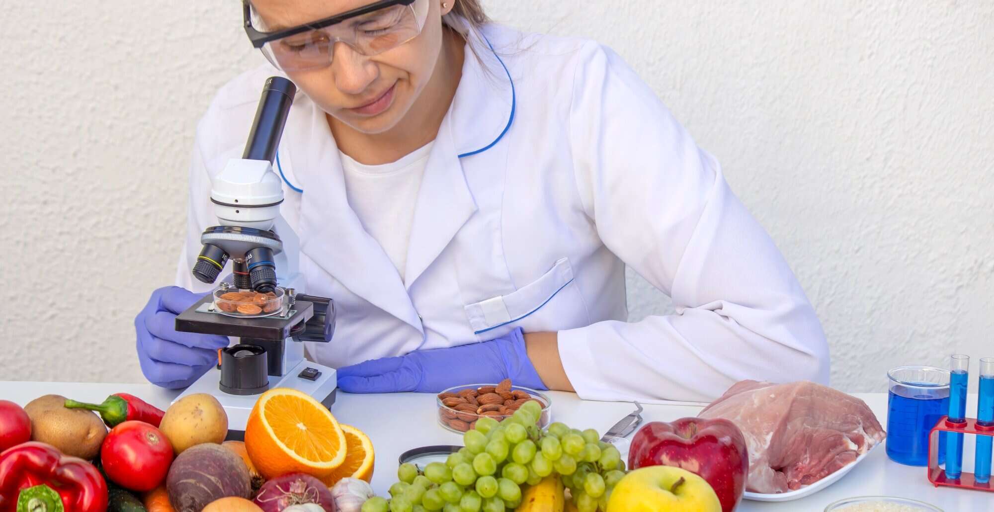 A food scientist measuring and inspecting natural fruit and vegetables in a lab. 