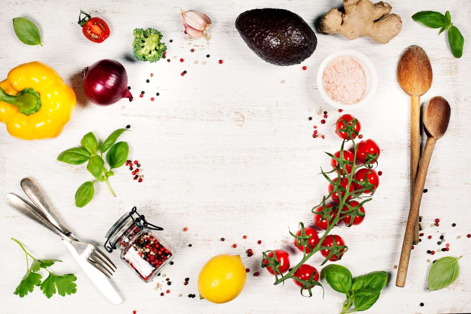 Flat lay of fresh vegetables, herbs, lemon, spices, and kitchen tools arranged for preparing NutriFusion blend.