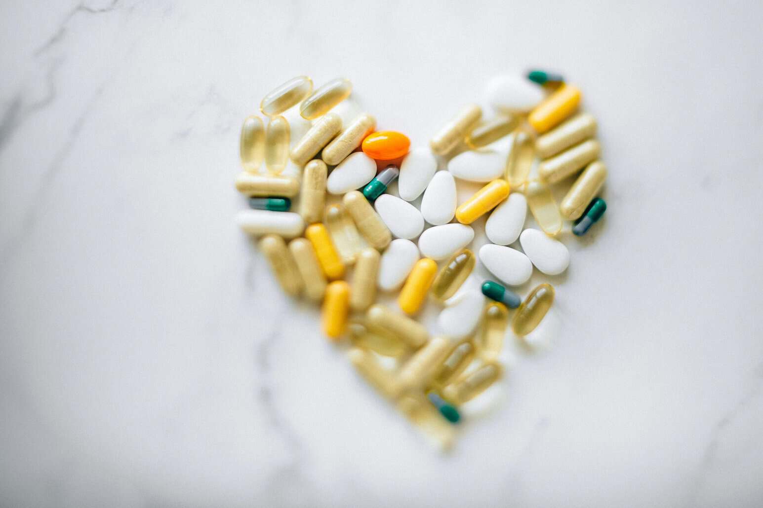 This photo shows supplements on a table shaped like a heart